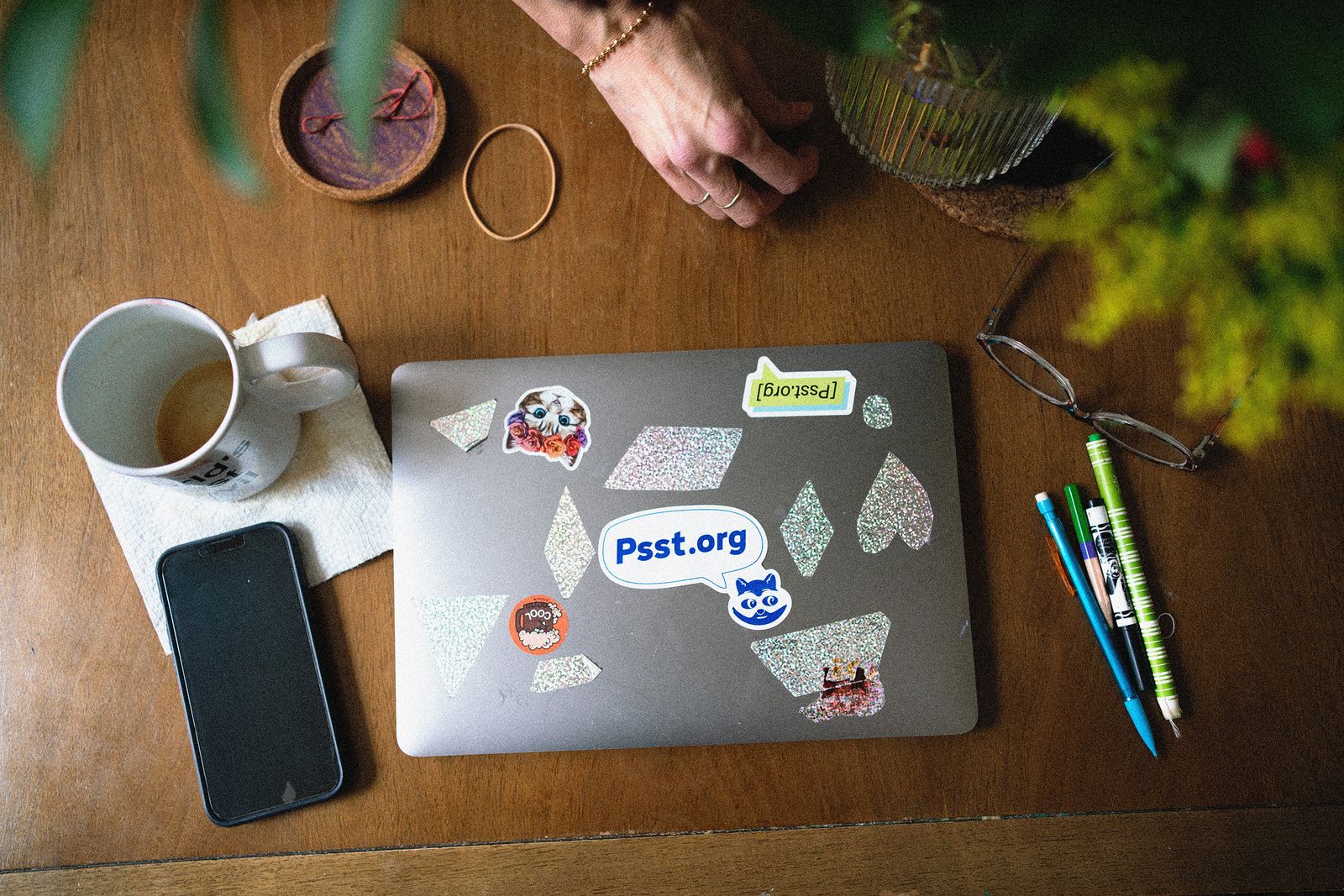 Image may contain Furniture Table Coffee Table Cup Pen Electronics Mobile Phone Phone Accessories and Bracelet
